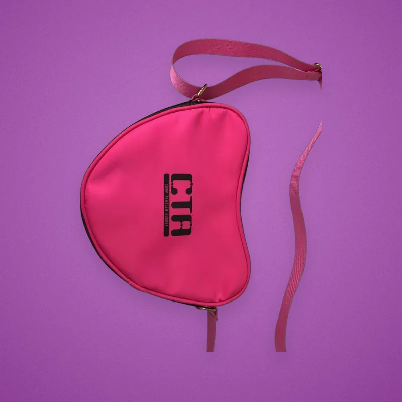 Pink half-moon crossbody bag printed with a camp logo