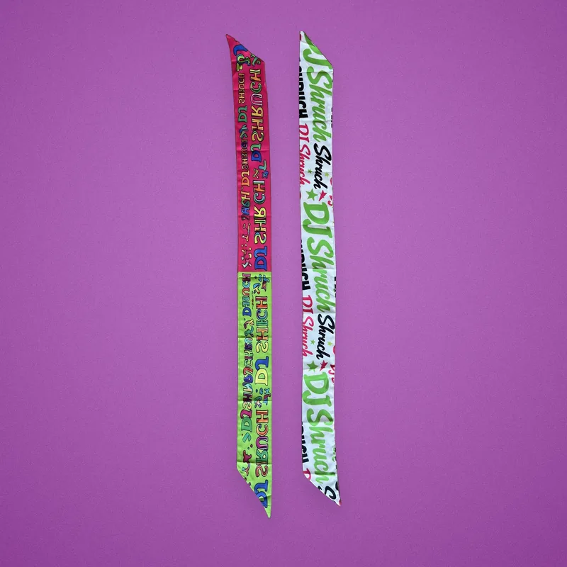 Two printed lanyards with a DJ's name in pink, green and white